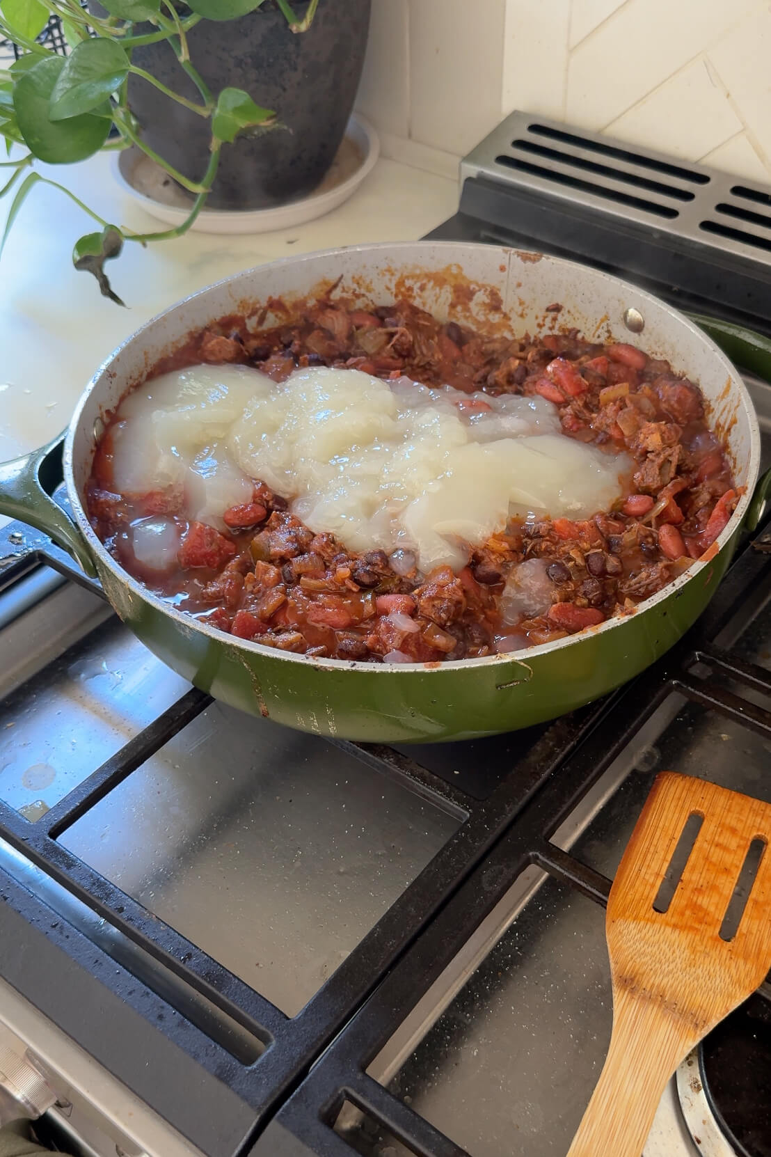 Adding homemade chicken stock to my brisket chili recipe.